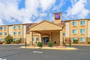 a large hotel with a sign on top of it at Sleep Inn in Hickory