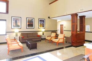 a waiting room with a couch and chairs at Comfort Suites in Twinsburg