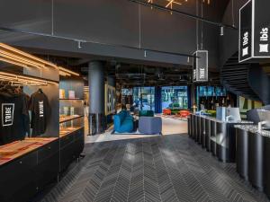 a view of a store with tables and chairs at TRIBE Budapest Stadium in Budapest