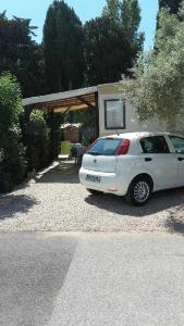 a white car parked in front of a house at vacances familiales dans camping avec piscine in Fréjus