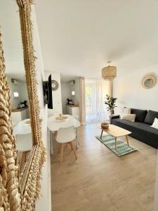 uma sala de estar com um sofá e uma mesa em Appartement Cosy - Cap d'Agde proche plage et port - Parking em Cap d'Agde