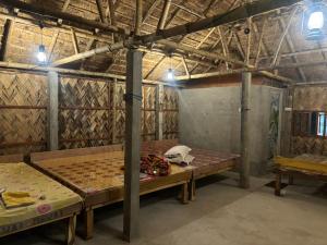a large room with two beds in it at Tapama Resort in Bakkhali