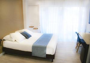 Postel nebo postele na pokoji v ubytování Tiercé Hotel