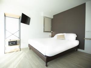Postel nebo postele na pokoji v ubytování Tiercé Hotel