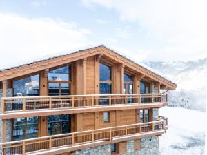 a log home in the snow with a balcony at Chalet Courchevel, 7 pièces, 12 personnes - FR-1-568-43 in Courchevel