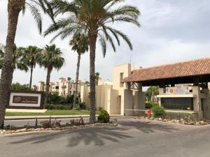 um hotel com palmeiras em frente a um edifício em Apartamento en Roda Golf em San Javier