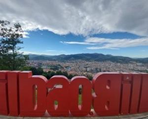 a red sign with a view of a city at Hotel Artxanda Bilbao in Bilbao