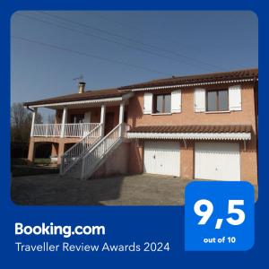 a house with a sign that says travel review awards at Grand Appartement avec cheminée dans maison, parking gratuit in Mionnay