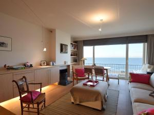 a living room with a view of the ocean at Golden beach 0203 with sea-view in De Haan in De Haan
