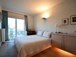 a bedroom with a large bed and a large window at Golden beach 0203 with sea-view in De Haan in De Haan