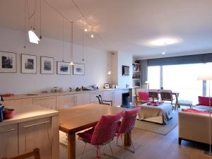 a kitchen and living room with a table and chairs at Golden beach 0203 with sea-view in De Haan in De Haan