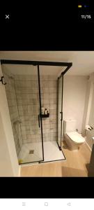 a bathroom with a glass shower and a toilet at Centro ciudad in Seville
