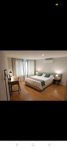 a bedroom with a large bed and a table at Centro ciudad in Seville