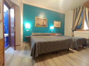Voodi või voodid majutusasutuse Hotel Santa Croce toas