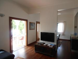 a living room with a flat screen tv at Floriana Villas in Cairns