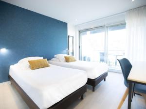 Postel nebo postele na pokoji v ubytování Tiercé Hotel