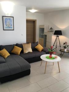 a living room with a couch and a table at Luxury apartment Cairos in Trogir