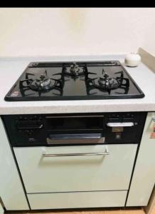 a stove top oven sitting in a kitchen at ZY House in Osaka