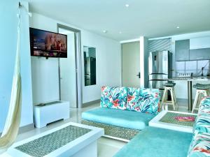 a living room with a couch and a kitchen at PALMETTO BEACH in Cartagena de Indias