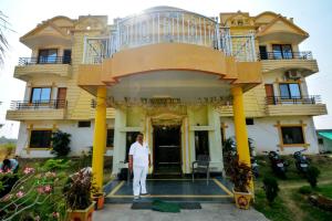 a man standing in front of a house at Gaurav Resort in Rāmtek