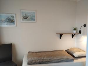 a room with a bed and a shelf on a wall at DUINZICHT 8 Bed by the Sea in Westkapelle