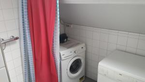 een wasruimte met een wasmachine en een wasmachine bij Single bed in quiet area in Eindhoven