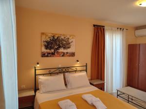 um quarto com uma cama com duas toalhas em Elanthi Village Apartments em Kalamaki