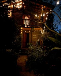 Una casa iluminada por la noche con luces de Navidad en Beehouse Arví Cabaña, en Guarne