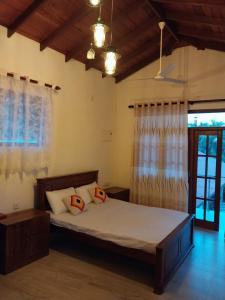 a bedroom with a bed with two pillows on it at Orchid Dream in Bentota
