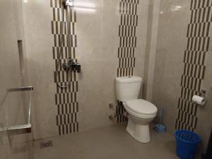 a bathroom with a toilet and a shower at Orchid Dream in Bentota