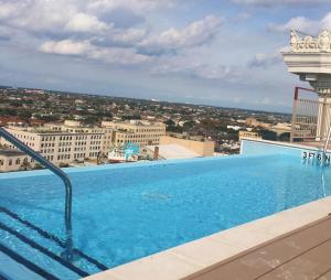 a swimming pool on the roof of a building with a view at Spacious Modern Condos near French Quarter in New Orleans