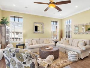 a living room with couches and a ceiling fan at Playa Panferio in Pensacola Beach