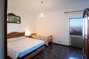 a bedroom with two beds and a window at Da Ernestina in Imperia
