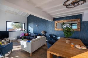 a living room with a couch and a table at Villa 4 Etoiles vue sur les Iles d'Or Carqueiranne Sea and Mountain Pleasure Villa vue mer 180 in Carqueiranne