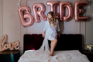 a girl standing on a bed in front of balloons at Boutique ALNIS in Constanţa