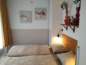 a bedroom with a bed and two pillows at SCHELP Bed by the Sea in Westkapelle
