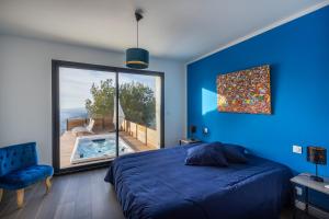 a bedroom with a bed and a large window at Villa 4 Etoiles vue sur les Iles d'Or Carqueiranne Sea and Mountain Pleasure Villa vue mer 180 in Carqueiranne +75 photos