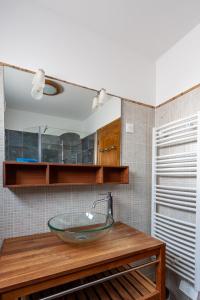 a bathroom with a glass sink on a wooden counter at Villa 4 Etoiles vue sur les Iles d'Or Carqueiranne Sea and Mountain Pleasure Villa vue mer 180 in Carqueiranne