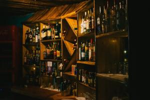 a bar with a lot of bottles of alcohol at Patamu Restaurant & Lodge in Karatu