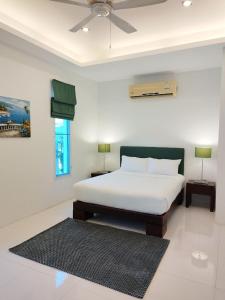a bedroom with a bed and a ceiling fan at Kamala pool Villa in Kamala Beach
