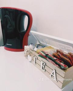 a red coffee mug next to a box of hot dogs at Apartamente 9 - Naomi in Baile Felix
