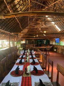 a long table with black birds sitting on top of it at Patamu Restaurants Lodge & Safaris in Karatu