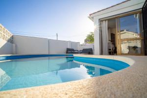 a swimming pool with blue water in a house at Villa Jazmin in Fuengirola