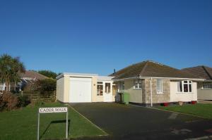 a house with a gate way sign in front of it at Wulfrun in Tywyn