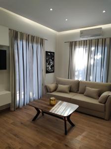 uma sala de estar com um sofá e uma mesa de centro em Kefalovriso Luxury Apartment 1 em Lepanto