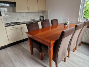 a kitchen with a wooden table and chairs at Camping Goedereede Chalet nr 16 in Goedereede