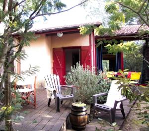 a deck with chairs and a red door at Pretty house with double terrace near the ocean in Moliets-et-Maa +15 photos