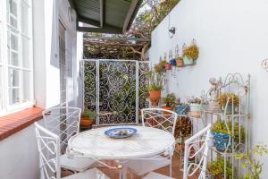 an outdoor patio with a table and chairs at Hummingbird in Pretoria