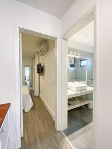 a white bathroom with a sink and a mirror at m a r ė a in José Ignacio