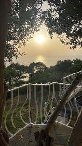 a view of a fence with the sun in the background at La GEMMA di Orrico in Anacapri